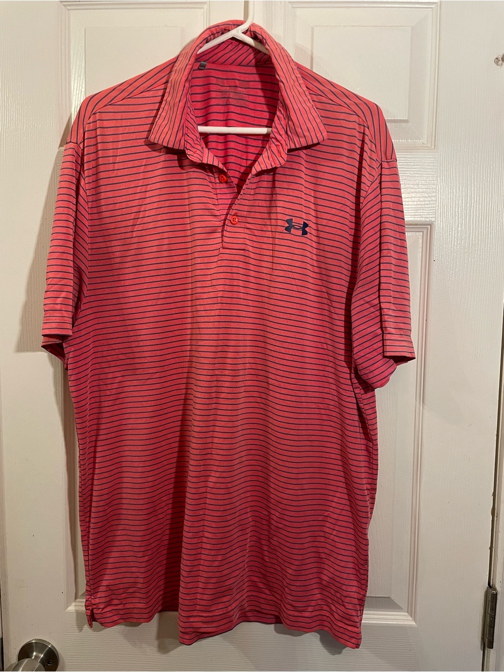 Under armor playoff polo featuring a salmon pink